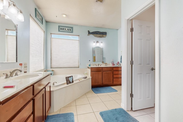 bathroom featuring tile patterned flooring, vanity, and a tub