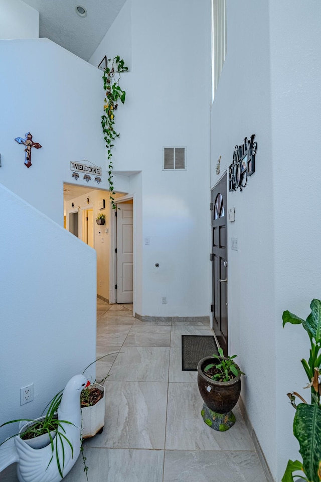 hallway with a towering ceiling