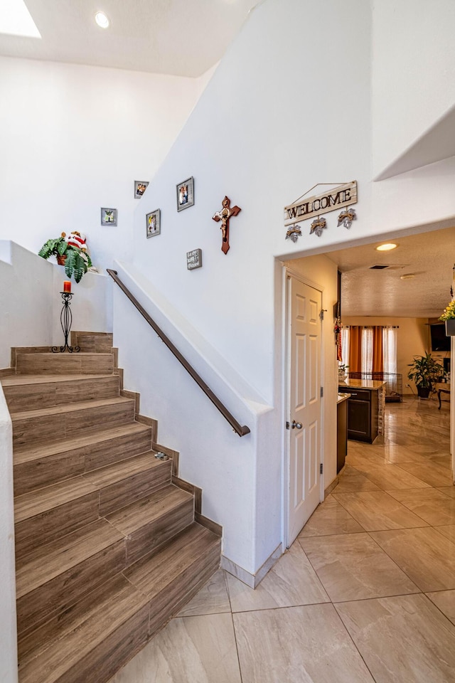 stairs featuring a skylight