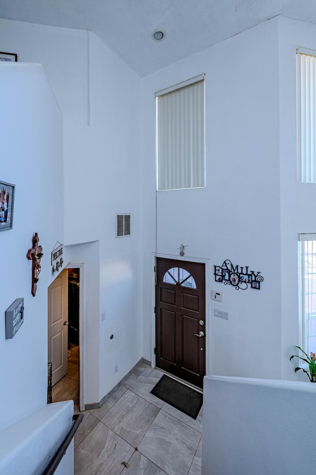 entryway featuring a high ceiling