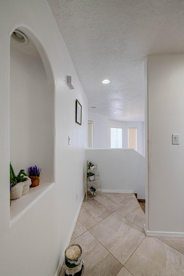 hallway featuring a textured ceiling