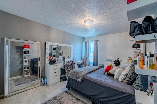 tiled bedroom featuring a textured ceiling