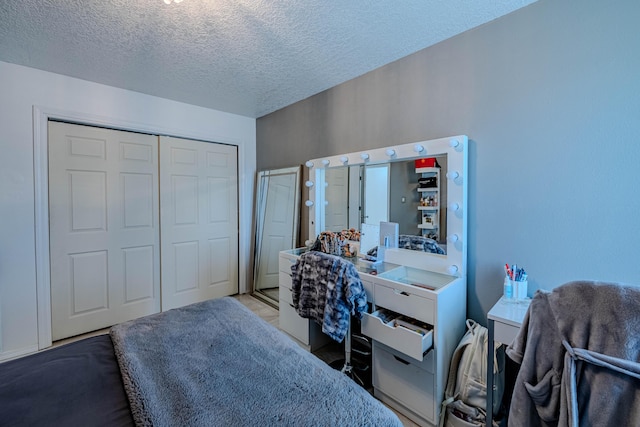 bedroom with a closet and a textured ceiling