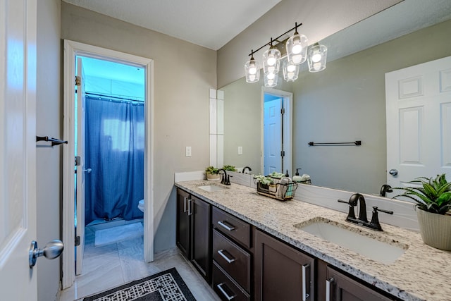 bathroom featuring vanity, toilet, and walk in shower