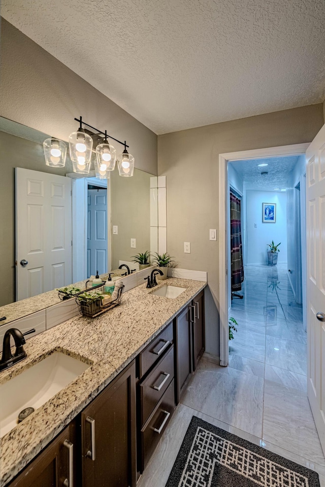 bathroom with vanity and a textured ceiling