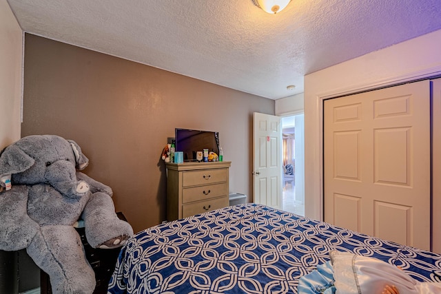 bedroom featuring a closet and a textured ceiling