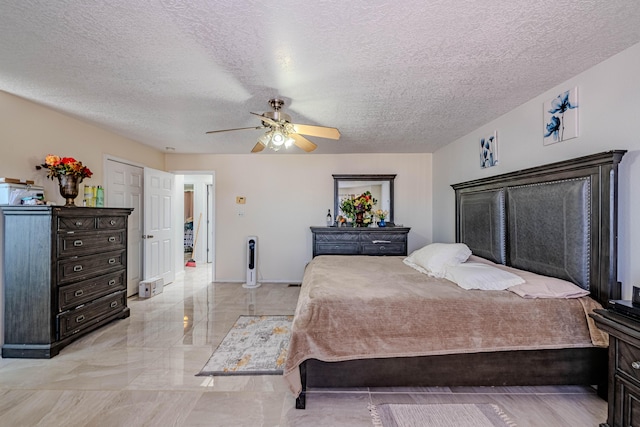 bedroom with a textured ceiling and ceiling fan