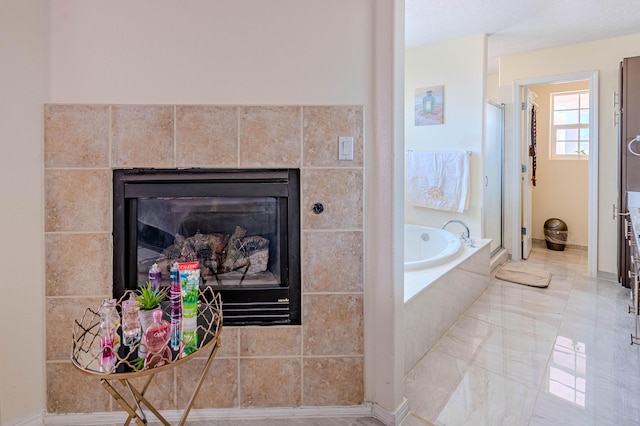 bathroom featuring separate shower and tub and a fireplace