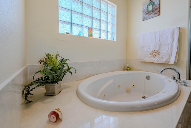 bathroom with a relaxing tiled tub