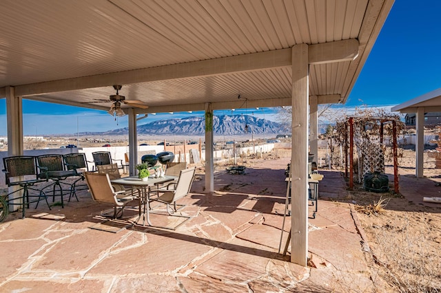 view of patio / terrace with a mountain view and ceiling fan