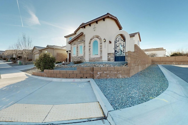 view of front of home with stone siding and stucco siding