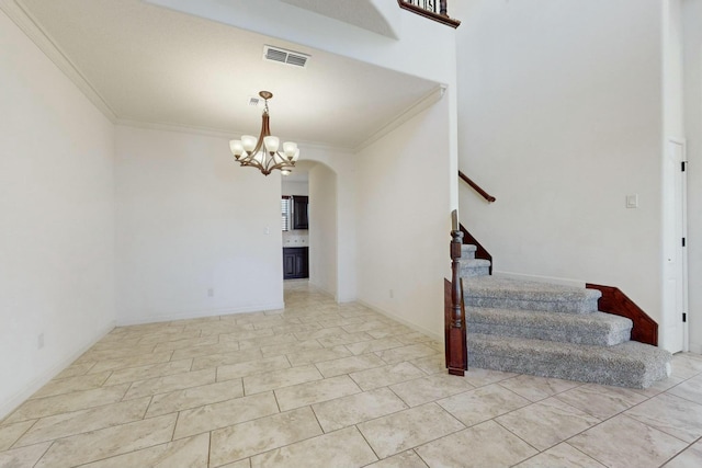 interior space with ornamental molding, arched walkways, visible vents, and stairs