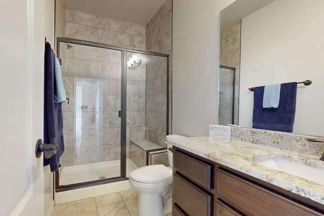 bathroom featuring toilet, a shower stall, and vanity