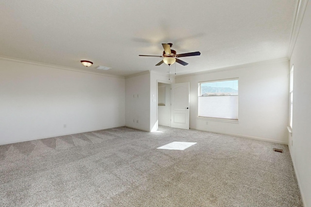 interior space with ornamental molding, light colored carpet, and a ceiling fan