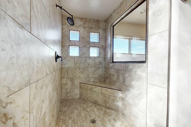 bathroom with a tile shower