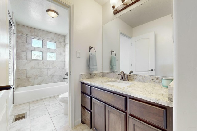 bathroom featuring toilet, vanity, visible vents, and shower / bathtub combination