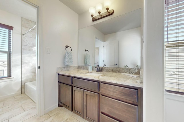 full bath with shower / tub combination, baseboards, and vanity