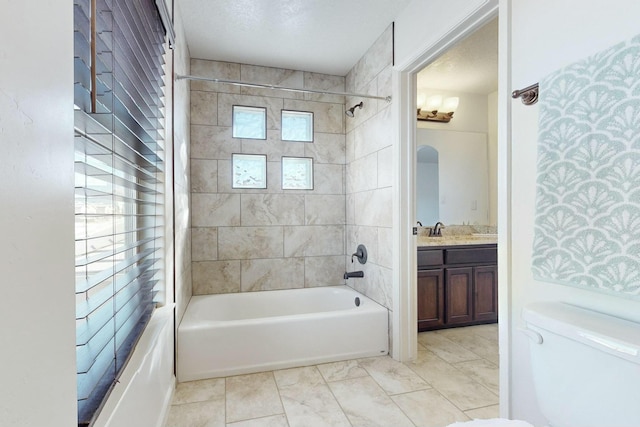 full bath featuring a textured ceiling, vanity, shower / tub combination, and toilet