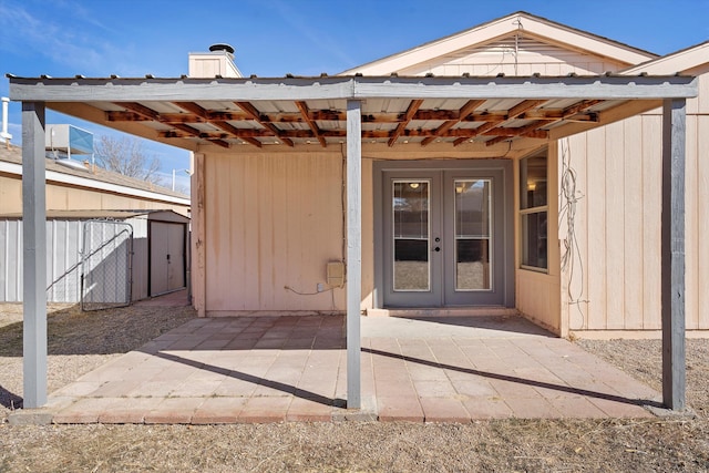 property entrance with a patio area and french doors