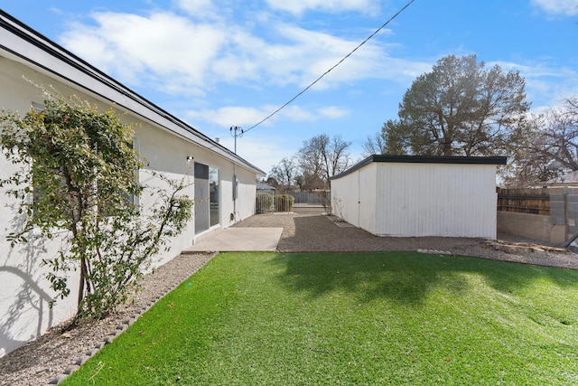 view of yard featuring a patio area and a shed