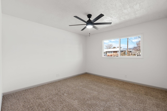 empty room with ceiling fan, carpet floors, and a textured ceiling