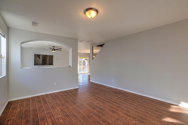 empty room featuring dark hardwood / wood-style flooring and a textured ceiling