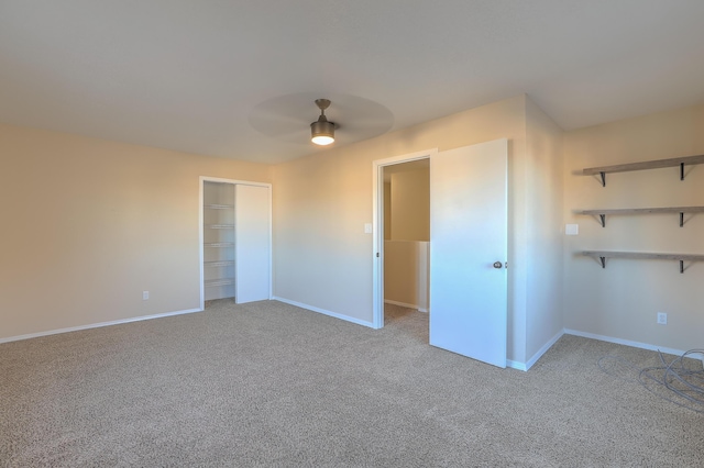 empty room with light colored carpet and ceiling fan