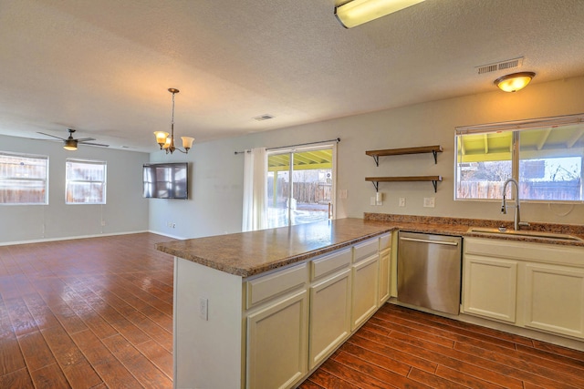 kitchen featuring dishwasher, sink, dark wood-type flooring, and kitchen peninsula