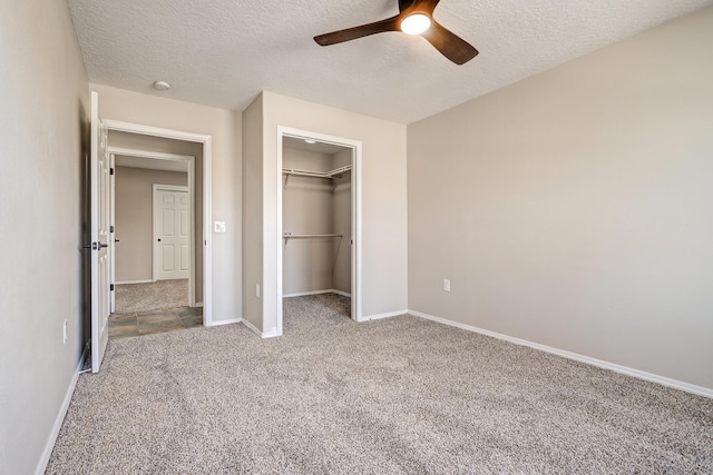 unfurnished bedroom featuring ceiling fan, light colored carpet, a closet, and a textured ceiling