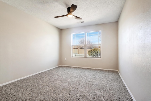 carpeted empty room with a textured ceiling and ceiling fan