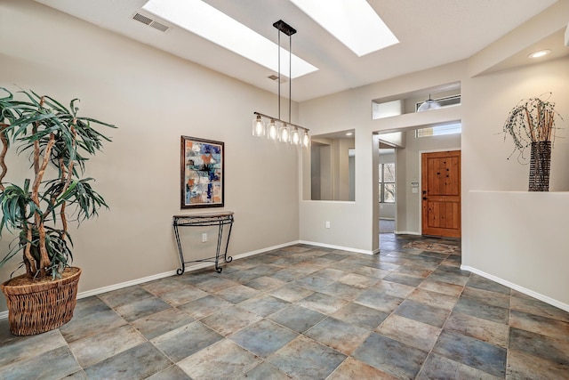 unfurnished dining area featuring a skylight