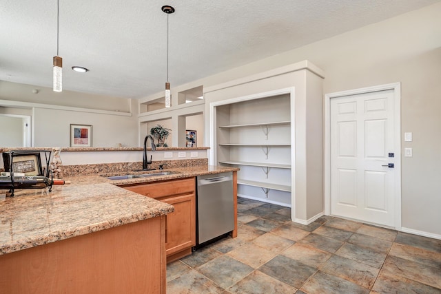 kitchen with stainless steel dishwasher, decorative light fixtures, sink, and a textured ceiling