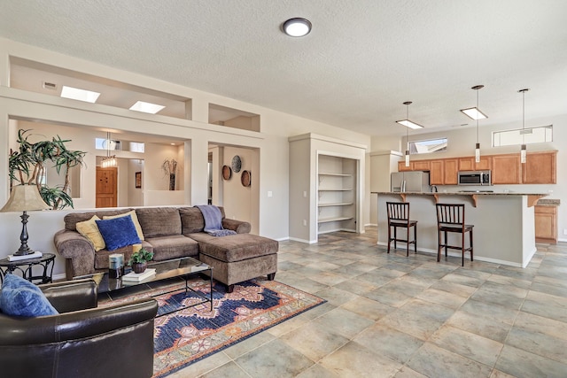 living room featuring built in shelves and a textured ceiling