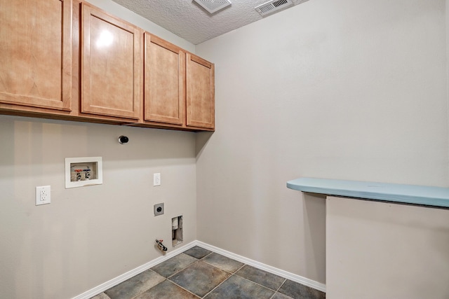 laundry area with cabinets, a textured ceiling, electric dryer hookup, washer hookup, and hookup for a gas dryer