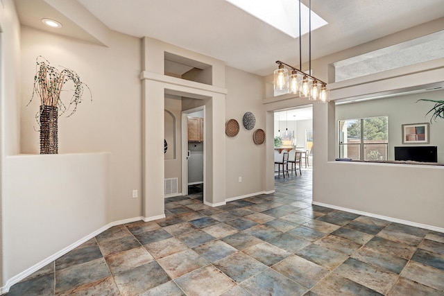 unfurnished dining area with a skylight