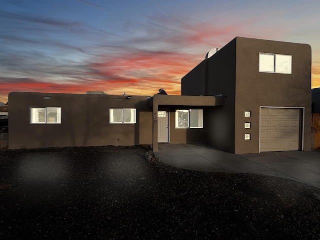 view of front of property with driveway and stucco siding