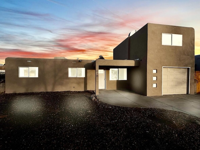 view of front of house with concrete driveway and stucco siding