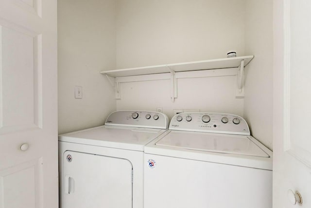 clothes washing area with washing machine and clothes dryer