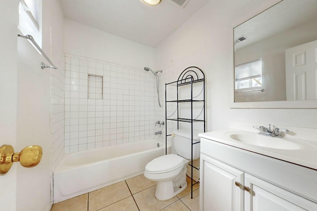 full bathroom featuring tiled shower / bath combo, vanity, tile patterned floors, and toilet