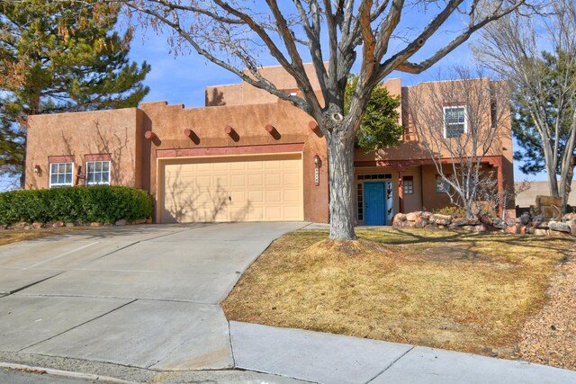 southwest-style home with a garage