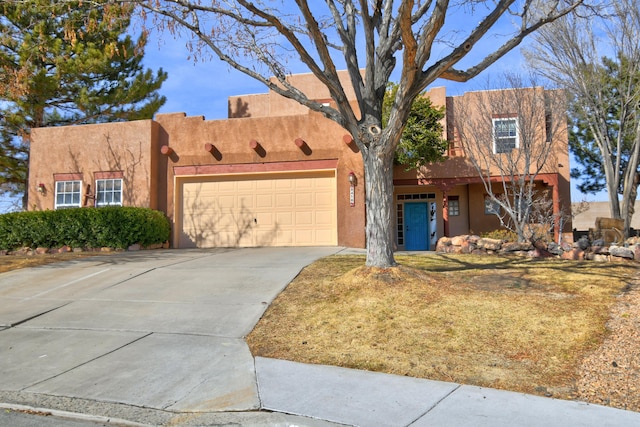 pueblo-style house with a garage