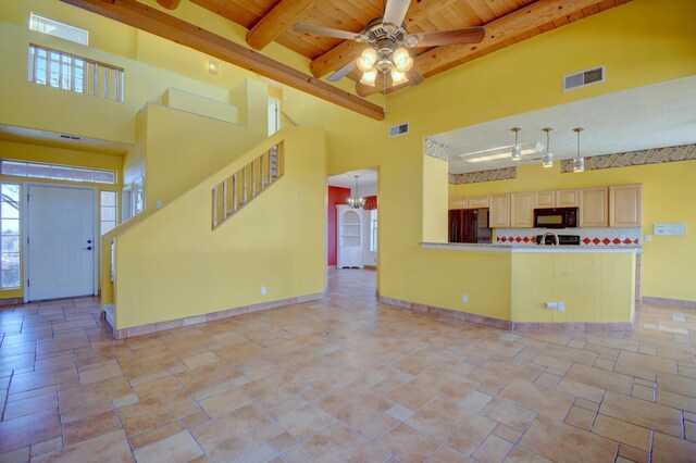 kitchen with ceiling fan with notable chandelier, range, a textured ceiling, and decorative light fixtures