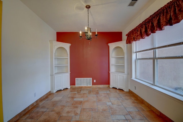 unfurnished dining area with vaulted ceiling and a chandelier