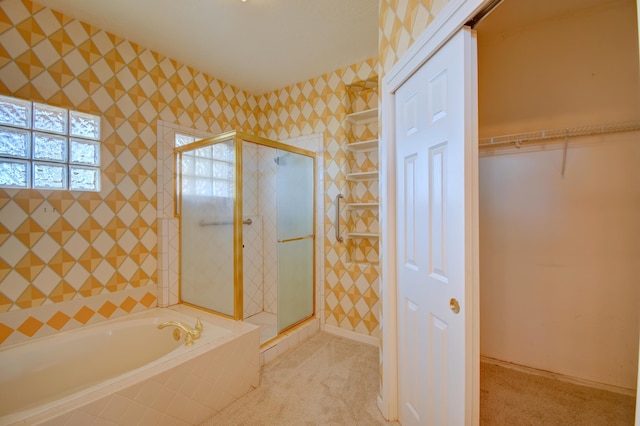 bathroom featuring separate shower and tub