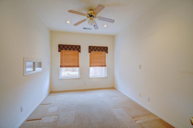 carpeted spare room with ceiling fan