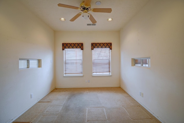 unfurnished room with light carpet and ceiling fan