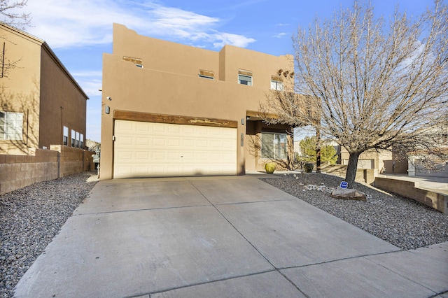 southwest-style home featuring a balcony and a garage