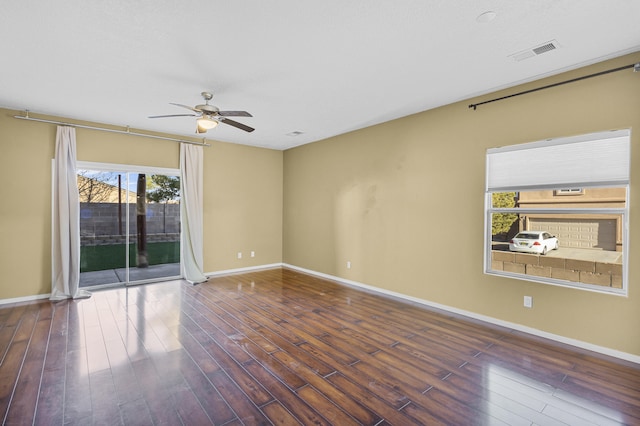 spare room with ceiling fan and dark hardwood / wood-style flooring