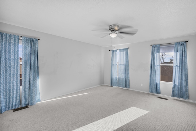 empty room featuring carpet floors and ceiling fan