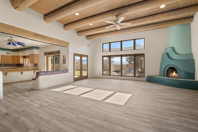 unfurnished living room featuring ceiling fan, light hardwood / wood-style floors, wood ceiling, and french doors